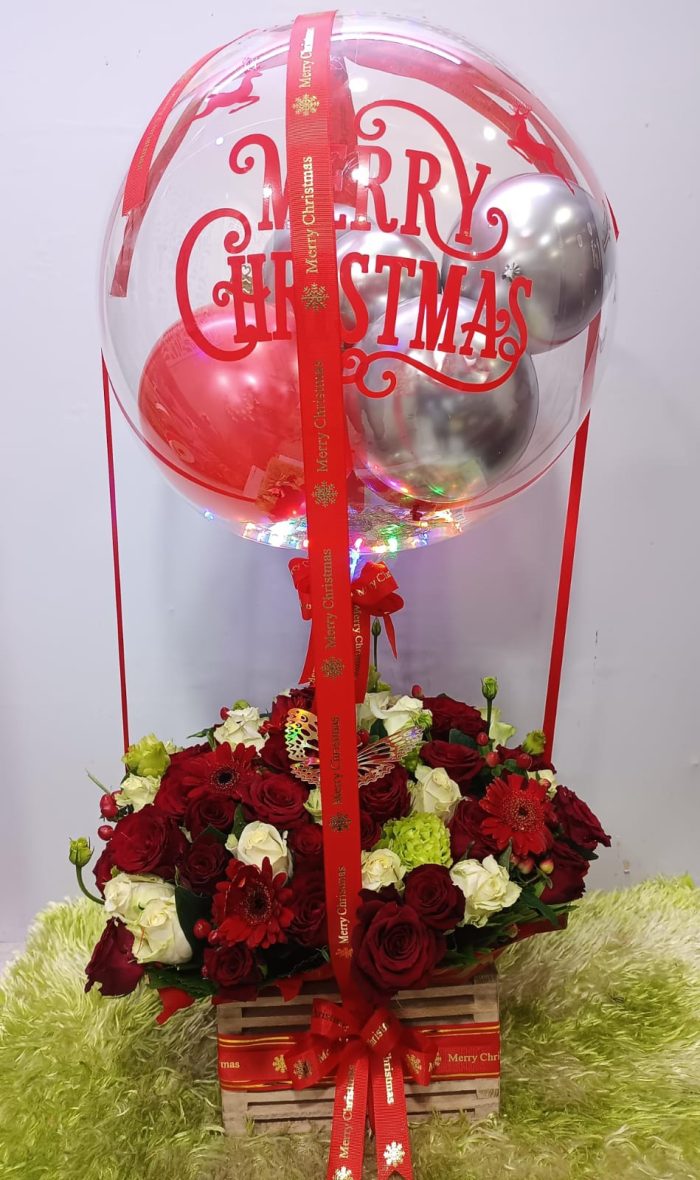Christmas flowers with a merry chtristmas balloon